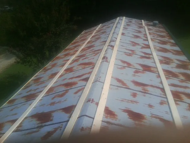 Rusted metal roof panels with new wood purlins before replacement — Storm Damage Roof Repair in Valhalla by Roofing Brothers