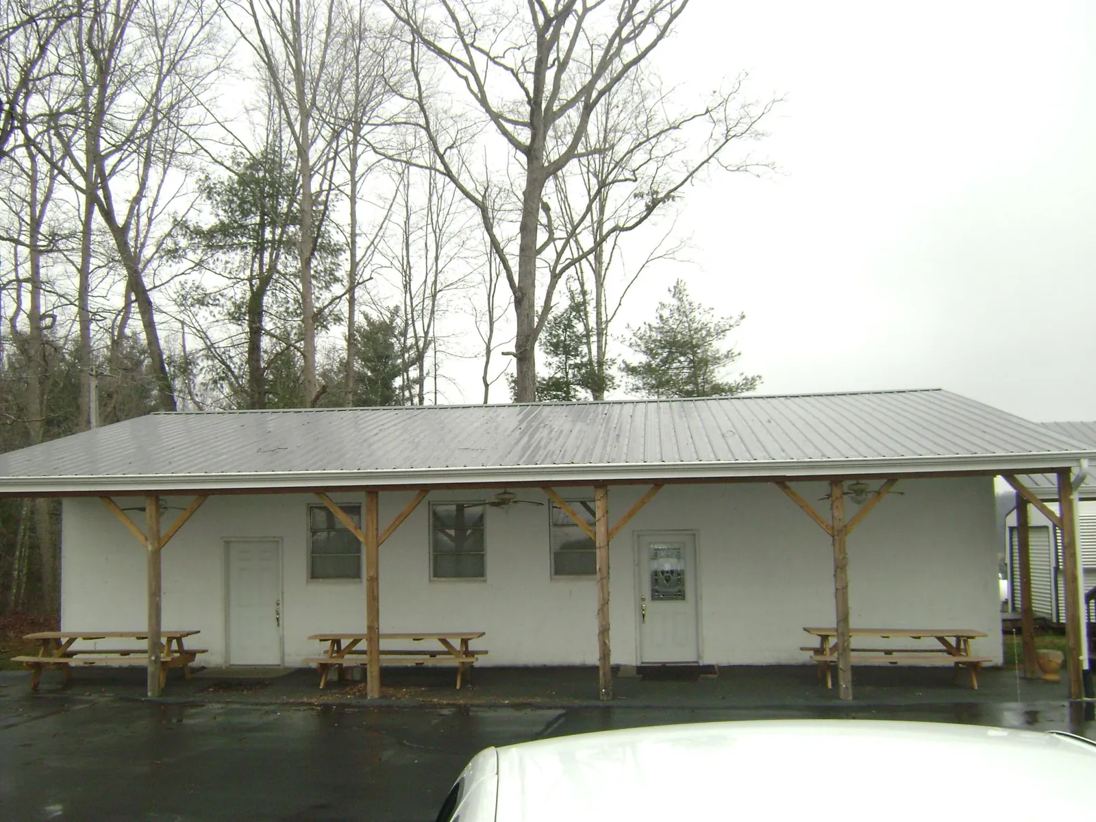 Gray metal roof over a block building with a timber post porch in Valhalla